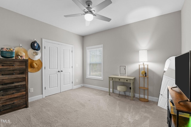 interior space with carpet floors, ceiling fan, and baseboards