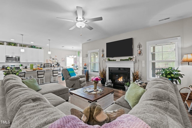 living room with plenty of natural light, visible vents, and wood finished floors