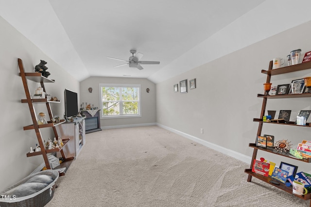 sitting room featuring lofted ceiling, carpet, a ceiling fan, and baseboards