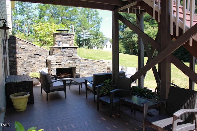 view of patio / terrace with a wooden deck and an outdoor living space with a fireplace