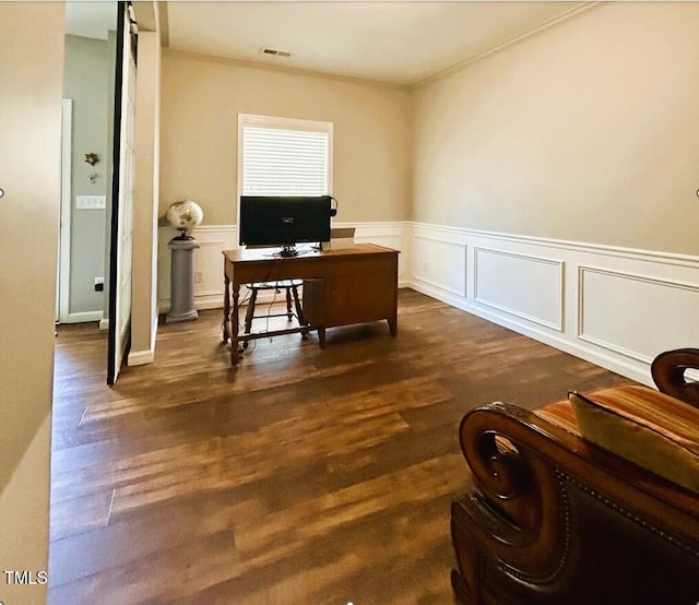 office featuring crown molding, visible vents, dark wood-style flooring, and wainscoting