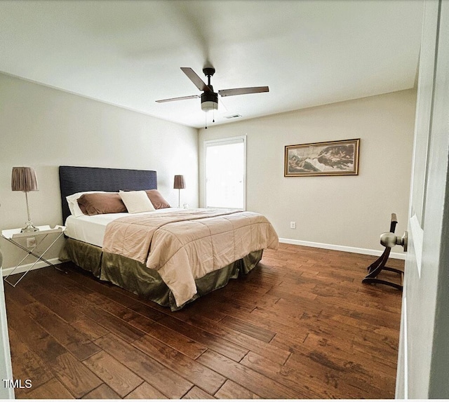 bedroom featuring wood-type flooring, visible vents, ceiling fan, and baseboards