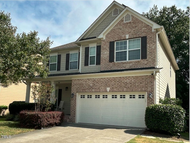 craftsman-style home with a garage, concrete driveway, and brick siding