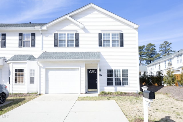 view of front of property with a garage, a shingled roof, and concrete driveway