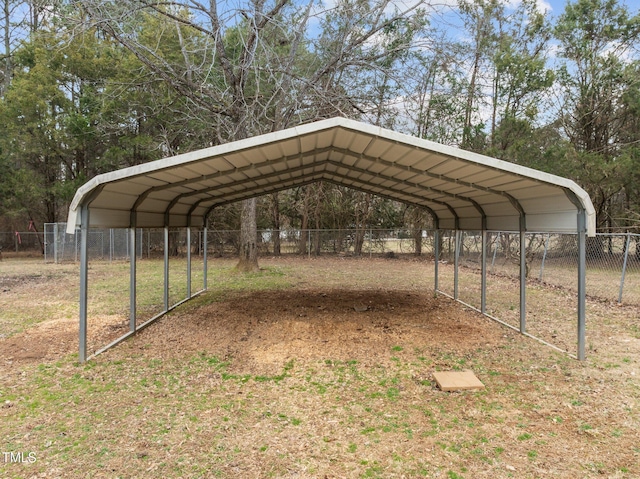 view of car parking with a carport and fence