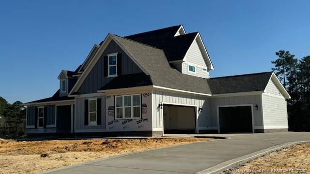 view of front of property with a garage, driveway, and board and batten siding