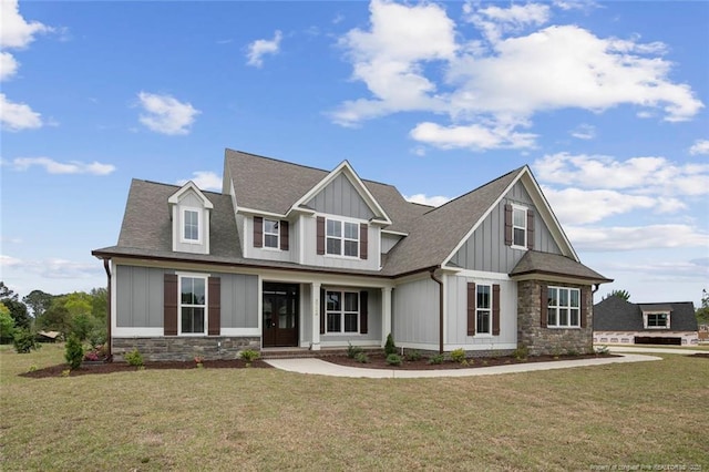 craftsman house featuring board and batten siding, a front yard, a shingled roof, and stone siding
