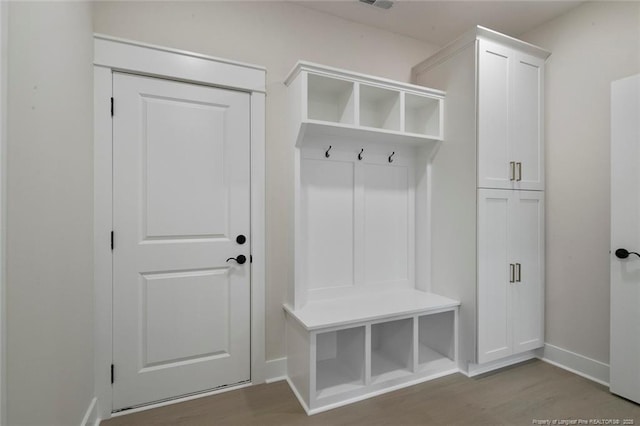 mudroom featuring wood finished floors and baseboards