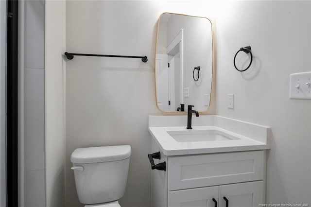 bathroom featuring toilet and vanity