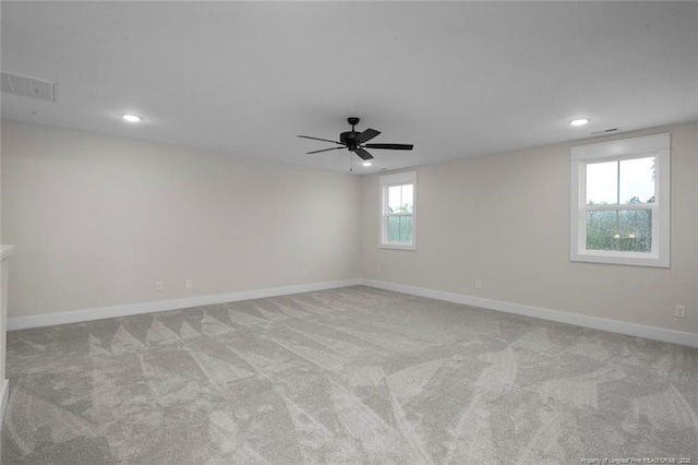 carpeted spare room with recessed lighting, visible vents, baseboards, and ceiling fan