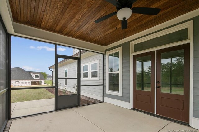 unfurnished sunroom with french doors and a ceiling fan