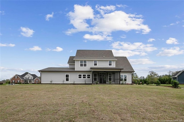 back of house with a sunroom and a yard