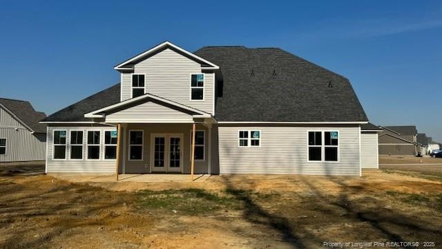 rear view of house featuring french doors