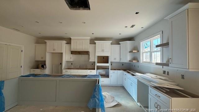 kitchen featuring white cabinets, open shelves, and a center island