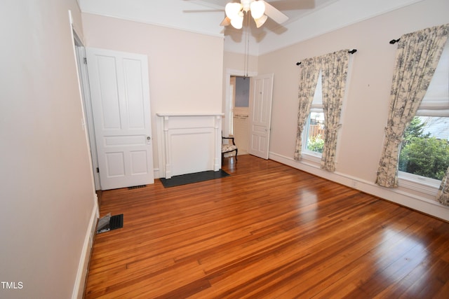 unfurnished bedroom featuring baseboards, visible vents, and wood finished floors