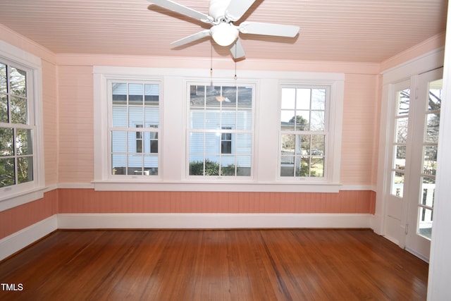 unfurnished sunroom featuring ceiling fan and a wealth of natural light