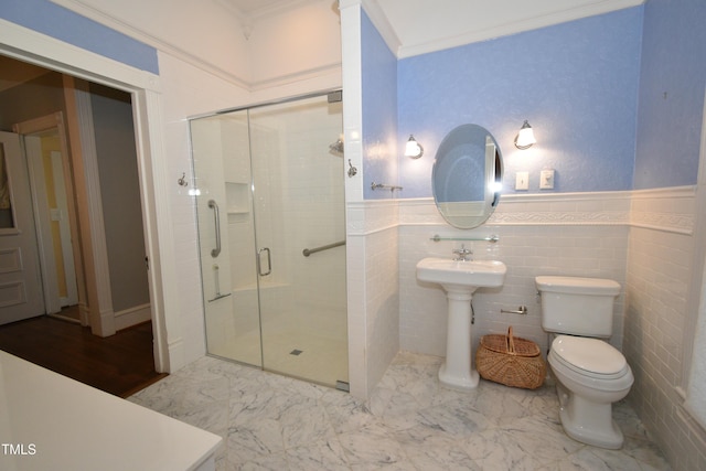 full bath with toilet, marble finish floor, crown molding, and a stall shower