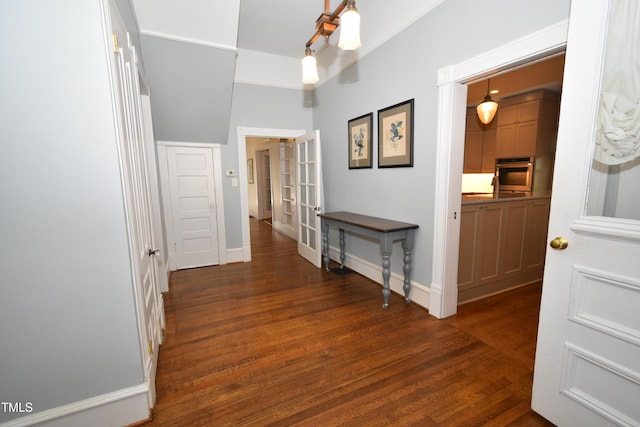 hallway featuring baseboards, dark wood-style flooring, and french doors