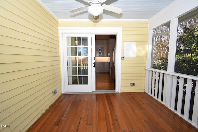 unfurnished sunroom with ceiling fan