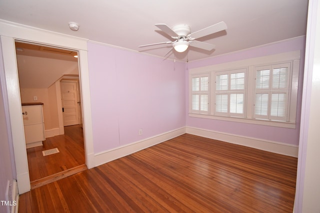 unfurnished room featuring baseboards, crown molding, a ceiling fan, and wood finished floors