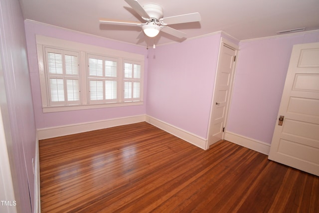 unfurnished room featuring a ceiling fan, visible vents, baseboards, and wood finished floors