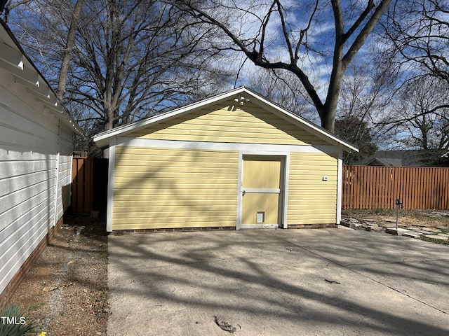 view of outbuilding with fence and an outdoor structure