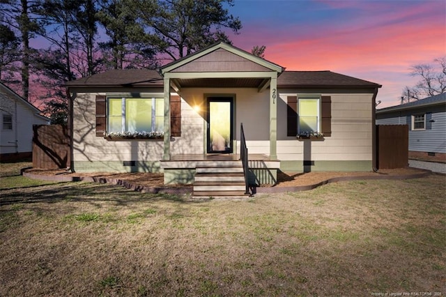 view of front of home featuring crawl space and a lawn