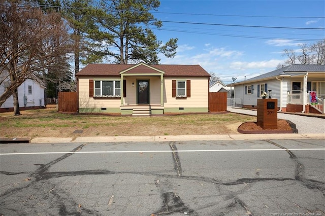 bungalow-style home with crawl space and fence