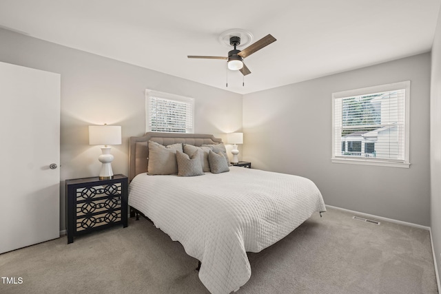 bedroom featuring baseboards, carpet, visible vents, and a ceiling fan