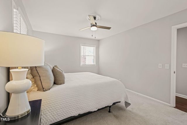 carpeted bedroom with a ceiling fan and baseboards