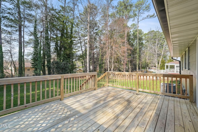 wooden deck featuring a yard