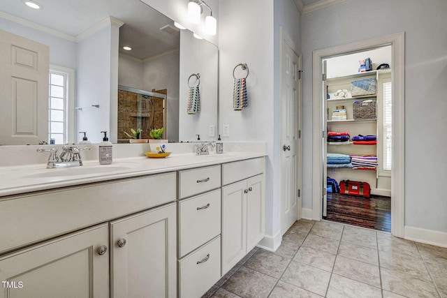 full bath with crown molding, a stall shower, visible vents, and a sink