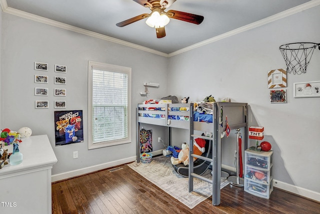 bedroom featuring baseboards, wood-type flooring, and ornamental molding