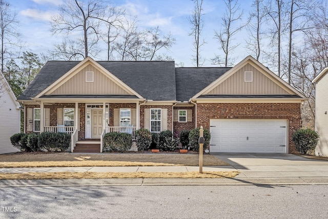 craftsman house featuring a porch, brick siding, concrete driveway, a garage, and board and batten siding