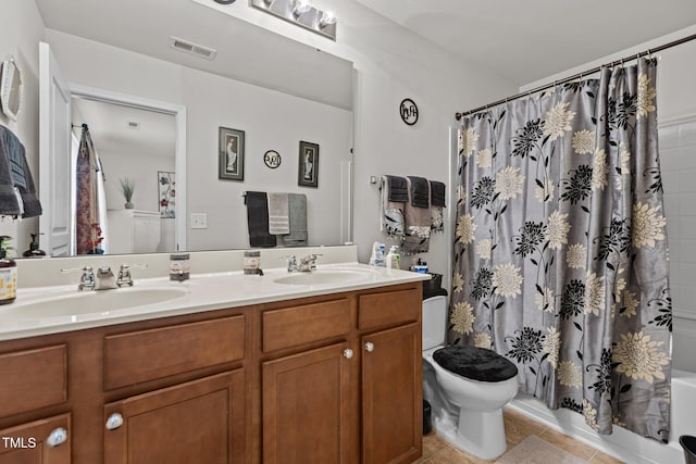 bathroom featuring double vanity, tile patterned flooring, a sink, and visible vents