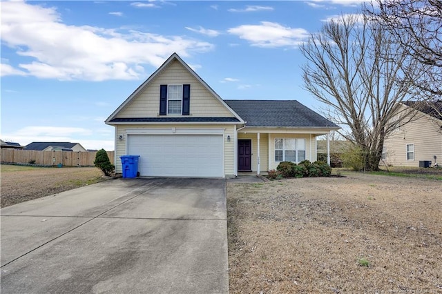 view of front facade featuring a garage, driveway, cooling unit, and fence