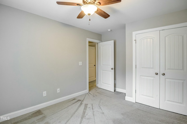 unfurnished bedroom featuring ceiling fan, a closet, carpet, and baseboards