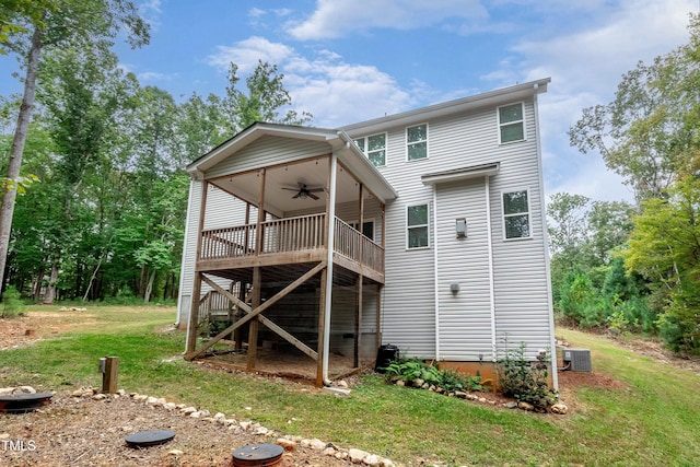 rear view of property featuring central AC, a lawn, a deck, and a ceiling fan