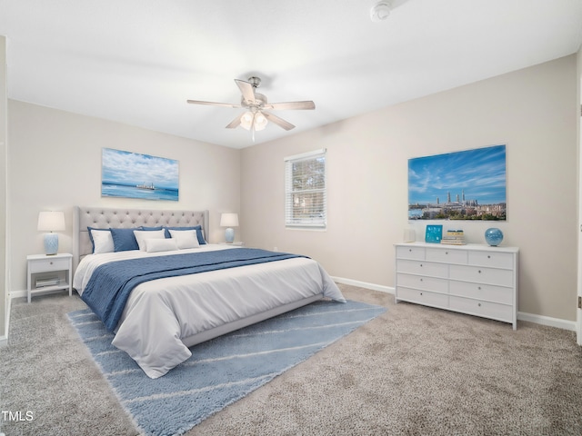 carpeted bedroom with ceiling fan and baseboards