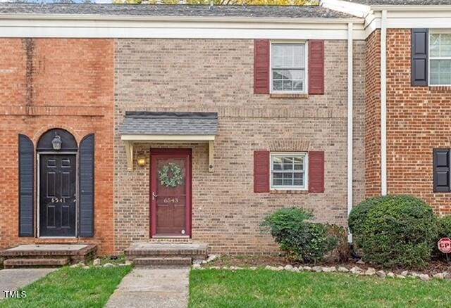 view of front of house featuring brick siding