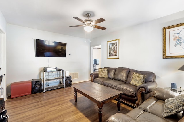 living area featuring ceiling fan, light wood-type flooring, and visible vents