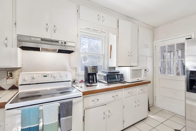 kitchen featuring white appliances, white cabinetry, under cabinet range hood, and light tile patterned floors