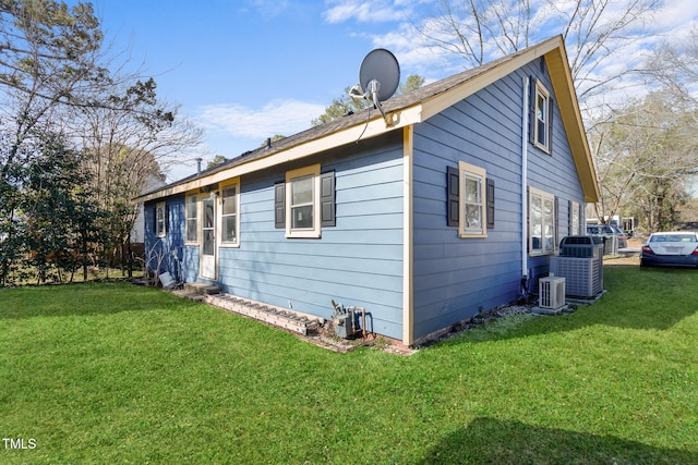 view of side of property with entry steps and a yard