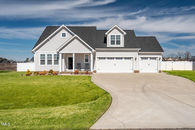 view of front of property with driveway, a front yard, and fence