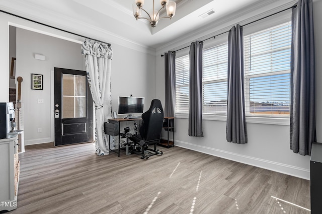 office space featuring visible vents, a raised ceiling, crown molding, and a chandelier