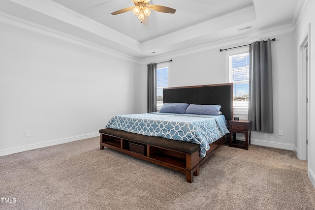 bedroom with visible vents, a raised ceiling, baseboards, carpet, and crown molding