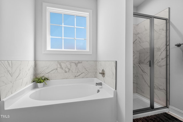 full bathroom with a garden tub and a shower stall