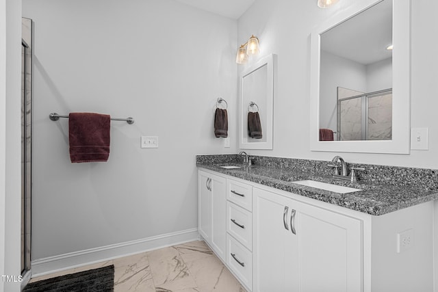 full bath featuring a shower stall, marble finish floor, a sink, and baseboards