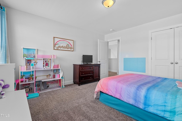 carpeted bedroom featuring a closet and baseboards