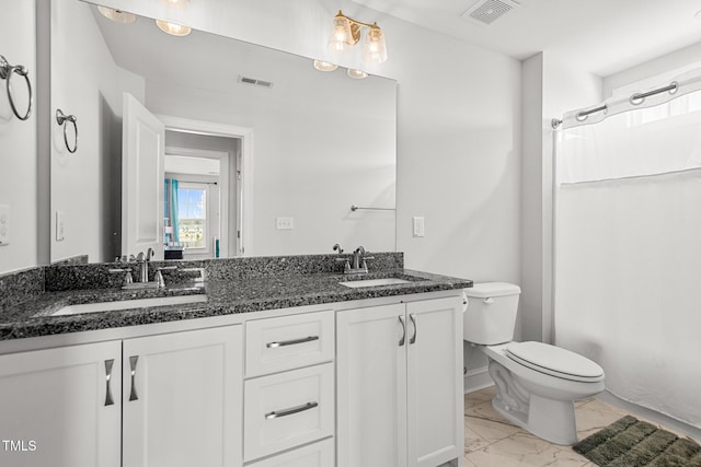 bathroom featuring marble finish floor, visible vents, and a sink